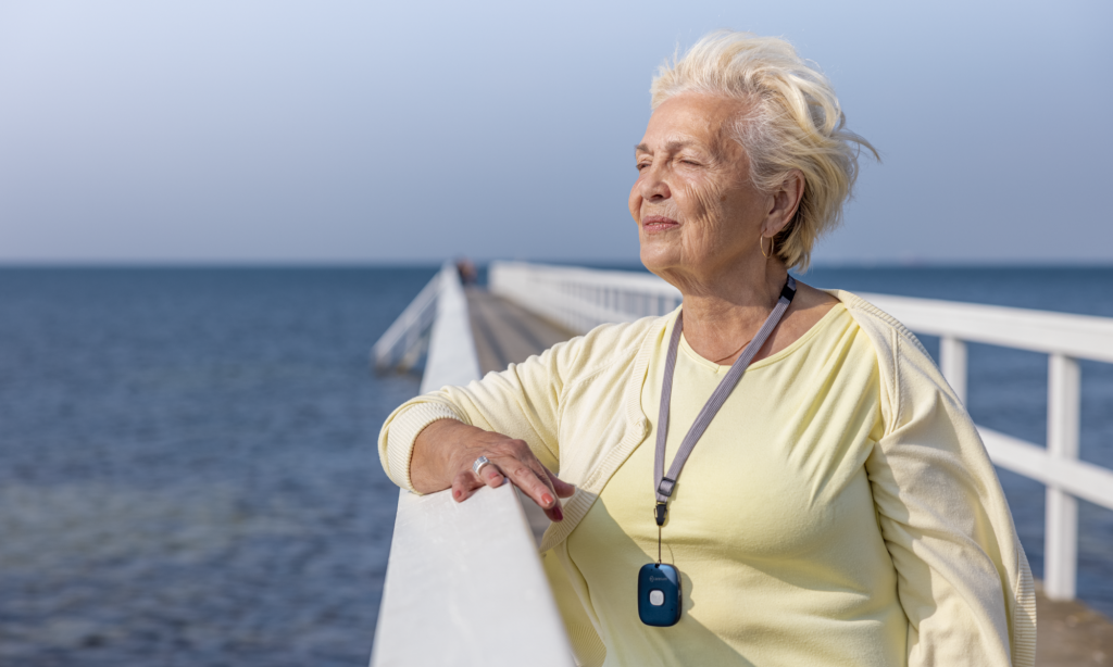Woman stands and looks out to sea.