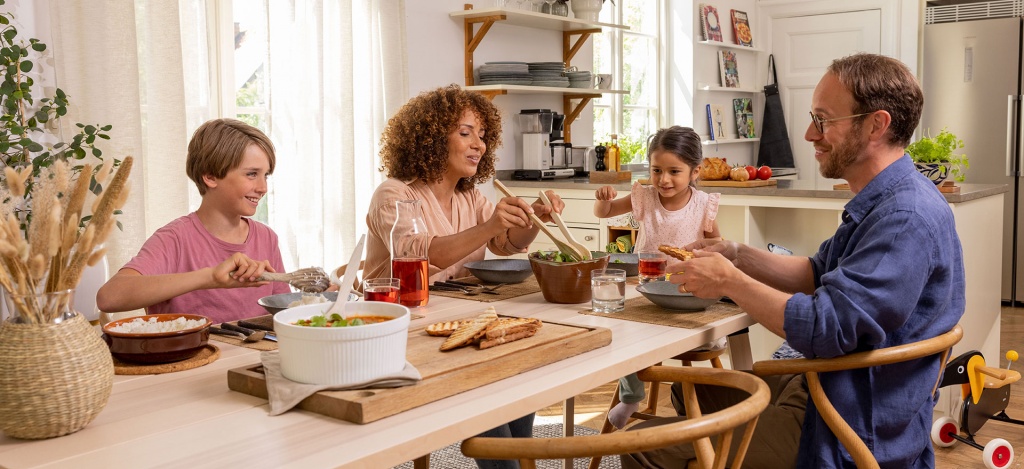 En familj som äter middag i ett uppvärmt hem